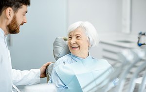 a patient smiling after receiving her new dental restorations