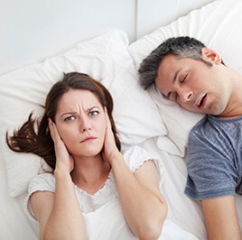 woman sleepless due to snoring husband
