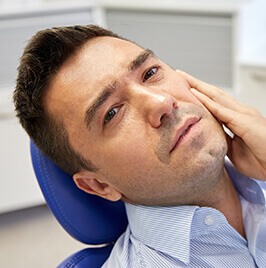 man in dental chair having toothache