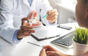 a dentist explaining how dental implants work