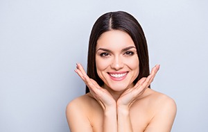 Woman smiling on gray background