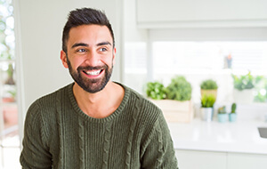 Smiling man happy he invested in dental implants