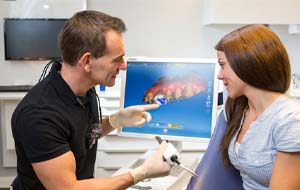 dentist showing a patient how their dental crown will look