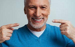 A man pointing to his mouth