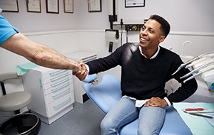 Emergency dentist in Jacksonville shaking hands with a patient