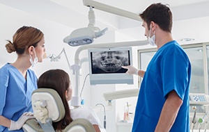 Emergency dentist in Jacksonville showing patient an X-ray