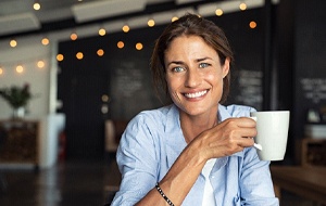 woman holding a white coffee mug