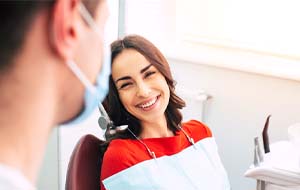 woman smiling at her implant dentist in Jacksonville