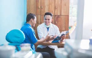 Dentist and patient engaged in friendly conversation