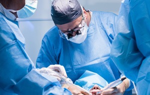 an oral surgeon performing dental implant placement