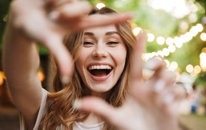 : a woman smiling with implant dentures in Jacksonville