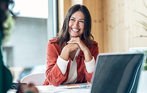 Woman smiling during meeting in office