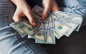 Woman counting cash for Invisalign