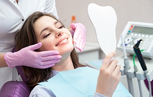 A young woman looking at the results of her smile makeover