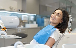 Smiling patient reclined in dental treatment chair