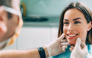 dentist checking smiling patient