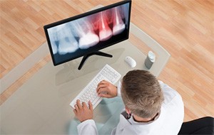 A dentist examining an X-ray.