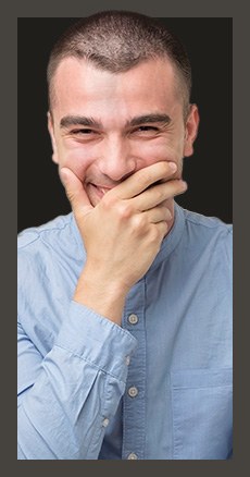 man covering his smile