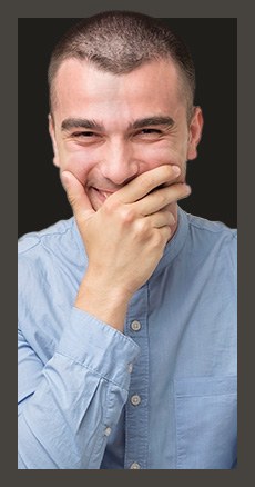 Grinning man covering his mouth with his hand