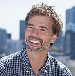 man sitting outdoors smiling