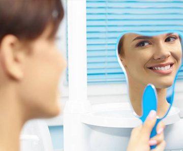 happy dental patient with mirror