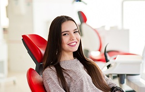 A happy, smiling woman who just received cosmetic dentistry