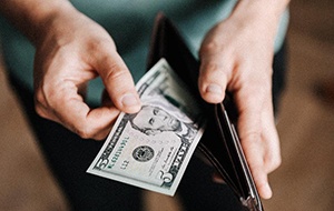 Man pulling cash out of a wallet