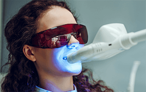 Woman having in-office whitening treatment