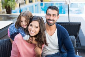 smiling family beside the pool