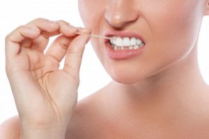 young woman using toothpick