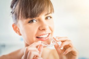 woman using invisalign