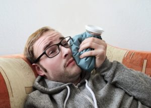 person with an ice pack on their mouth