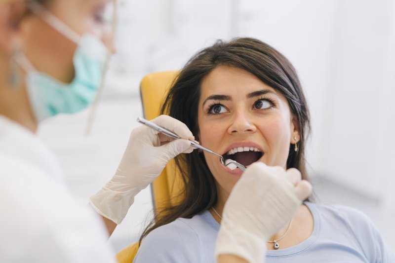 a woman having her teeth checked at the dentist’s office