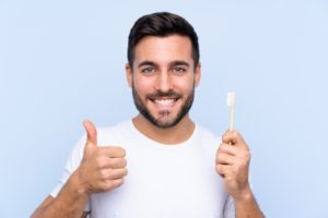 Happy man following dentist’s advice for great oral hygiene