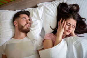 Woman annoyed by her partner’s snoring