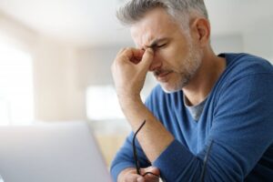 Man experiencing a migraine