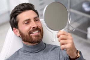Man smiling after cosmetic dental treatment