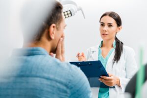 Dentist discussing root canal treatment with male patient